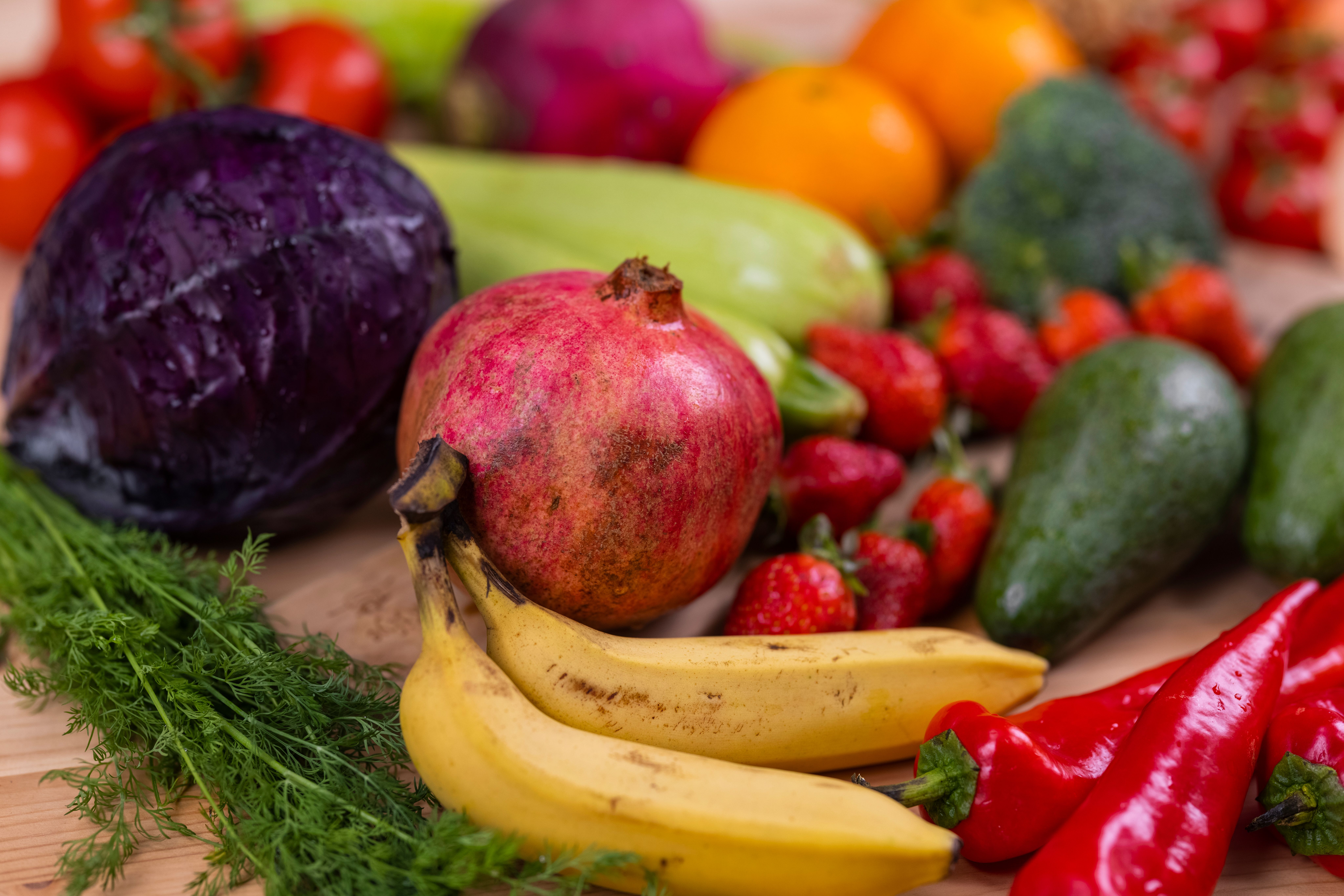 Colorful fresh fruits and vegetables rich in antioxidants on a wooden table